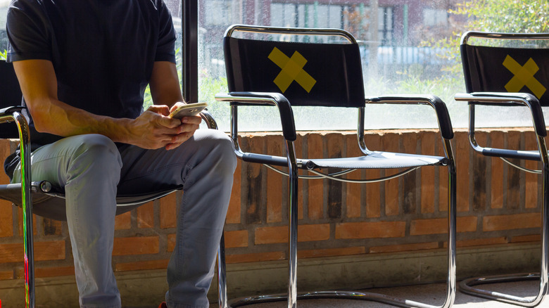 social distancing man seated in waiting room