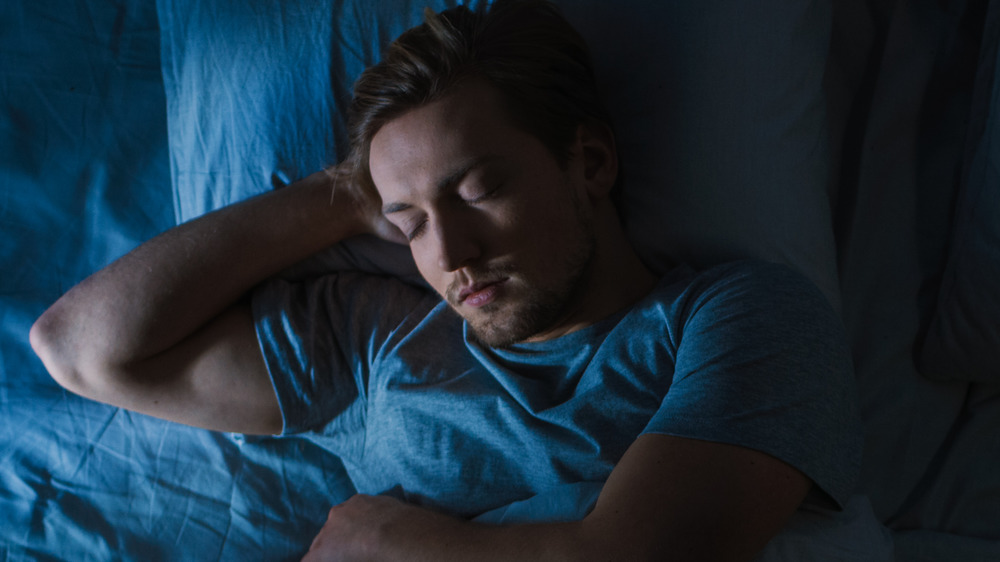 man sleeping in bed