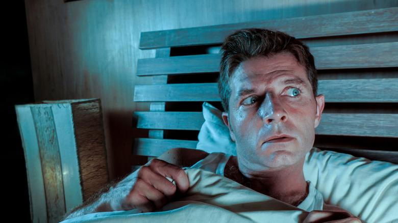 Man scared in bed