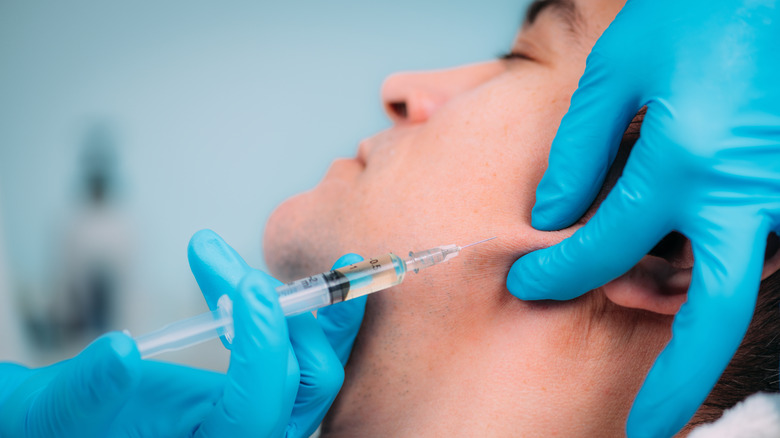 Needle injecting man's jaw