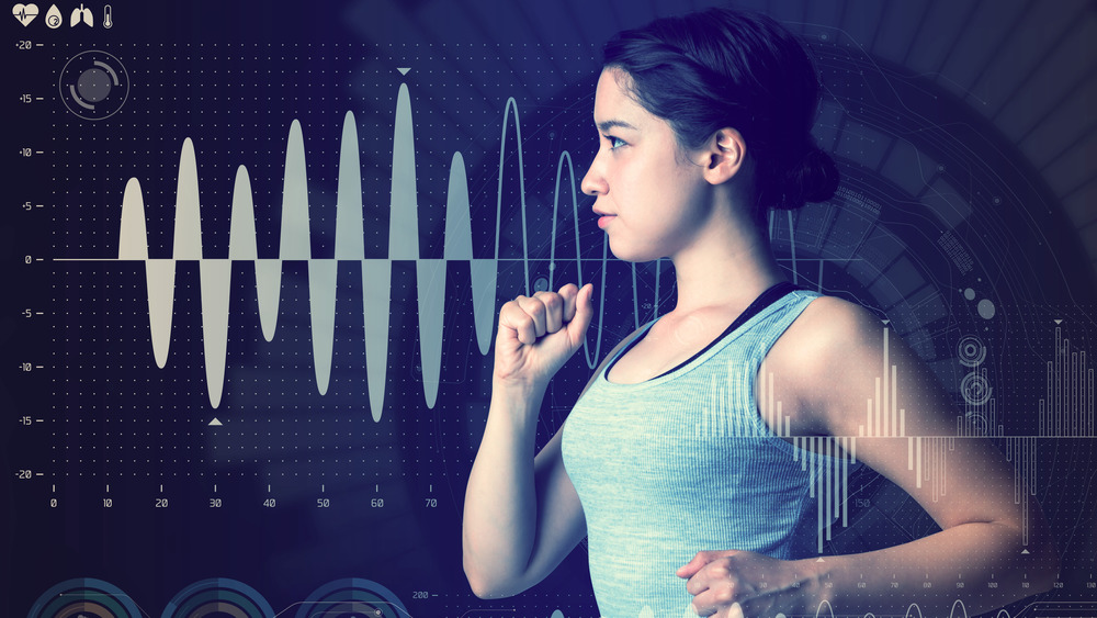 Young woman running with her health stats in the background 