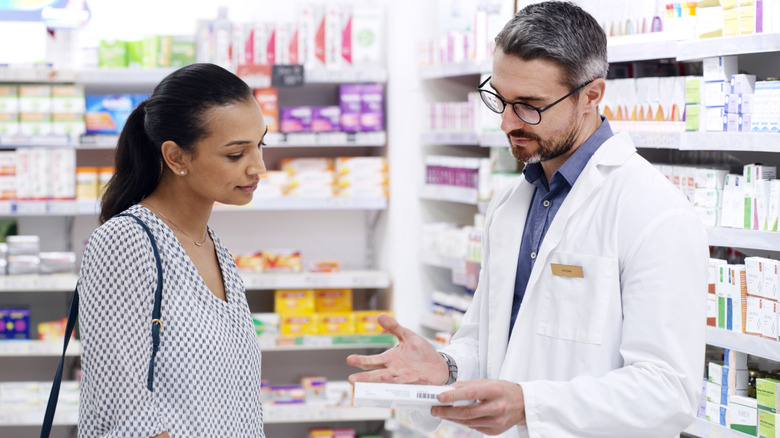 woman talking with pharmacist about medication