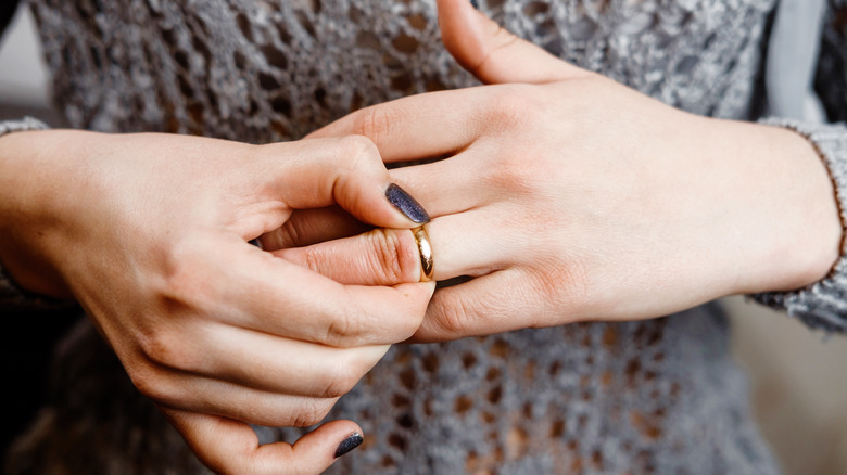 Woman removing ring from finger