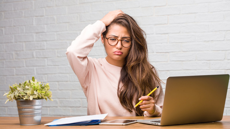 woman at the computer struggling to think