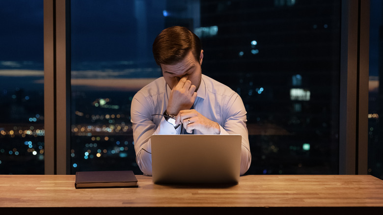 Man struggling to perform work tasks
