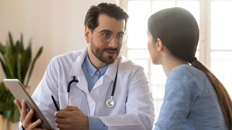 Young woman speaking with her doctor