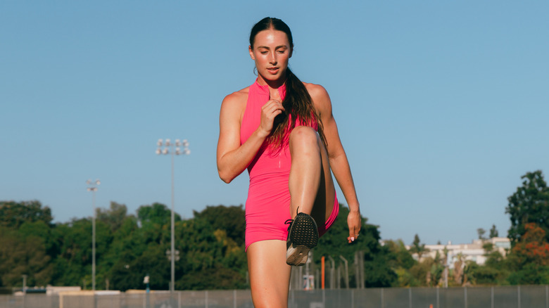 A runner doing a high-knee march