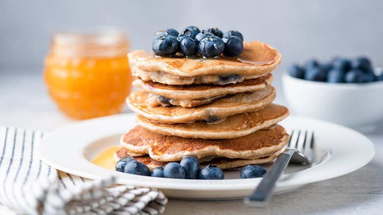 A stack of pancakes with blueberries on top