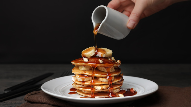 Pure maple syrup poured on pancakes