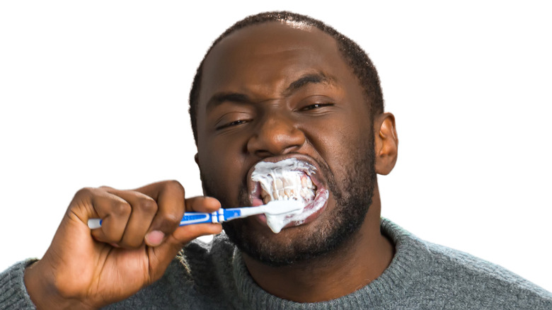 man brushing teeth hard