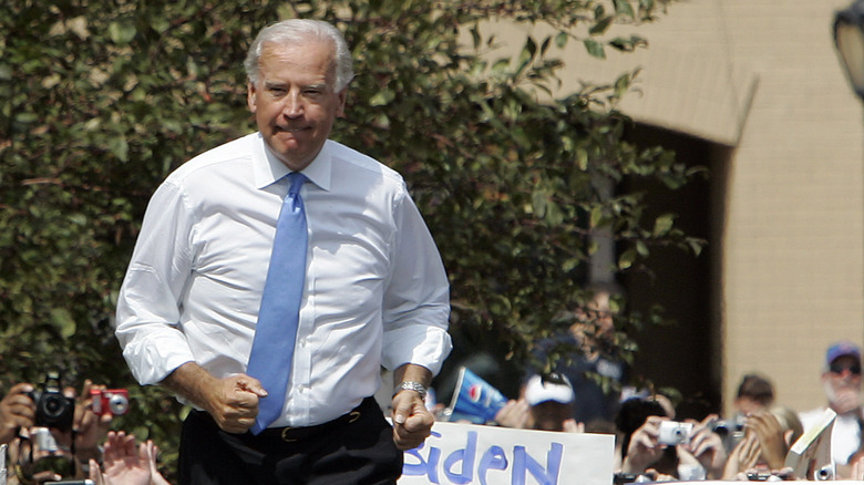 President Joe Biden jogging in a suit and tie 