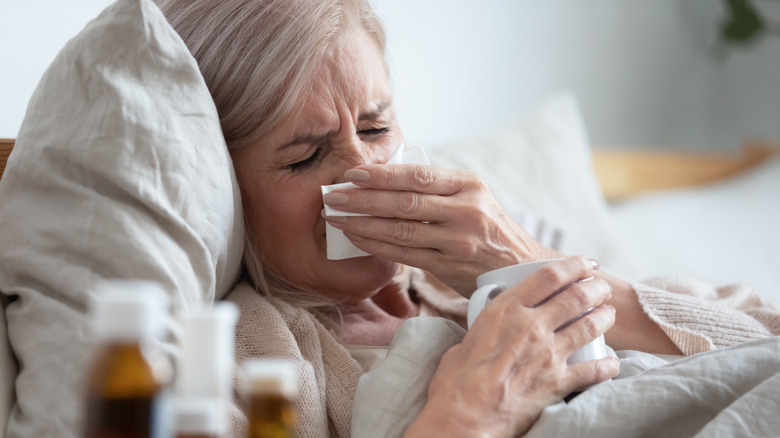 A woman is sick in bed