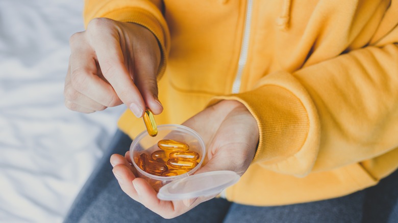 Woman taking omega-3 supplements