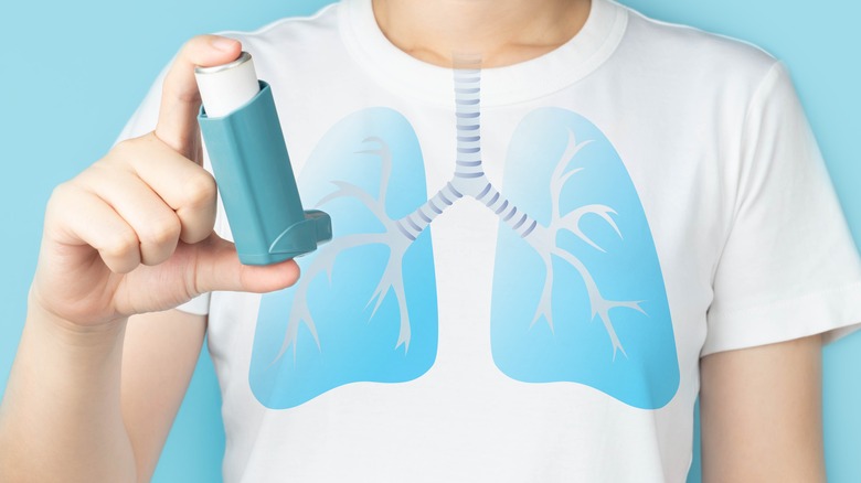 A patient holding an inhaler