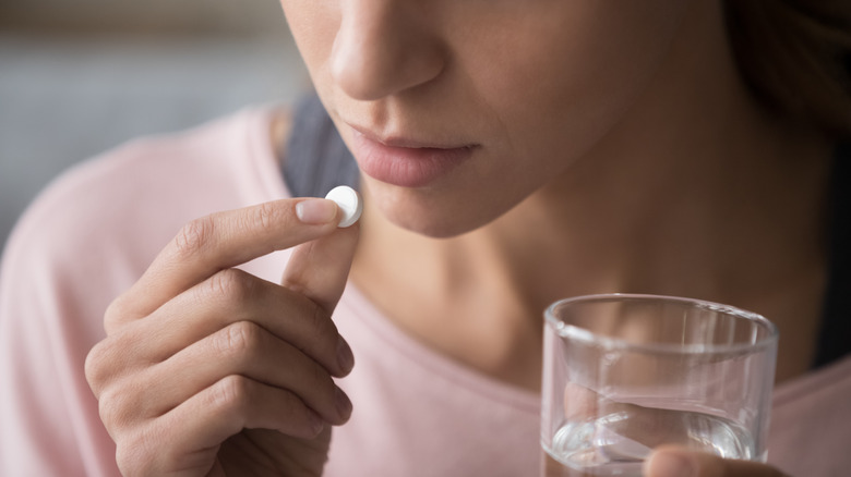 woman taking medicine