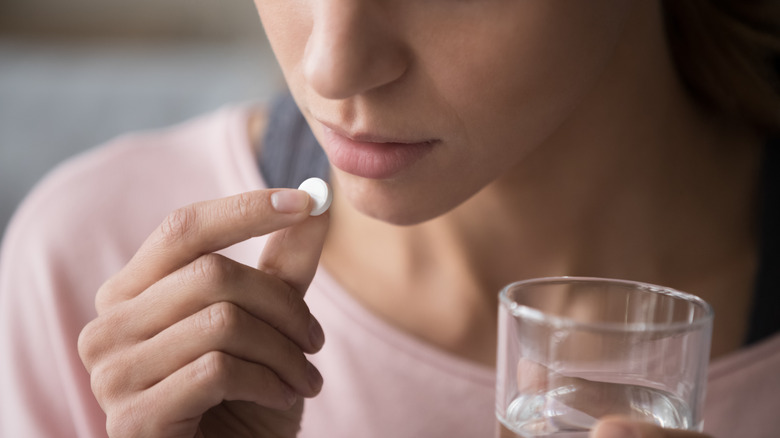 woman taking medicine