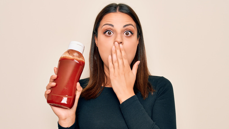 shocked woman holds ketchup 