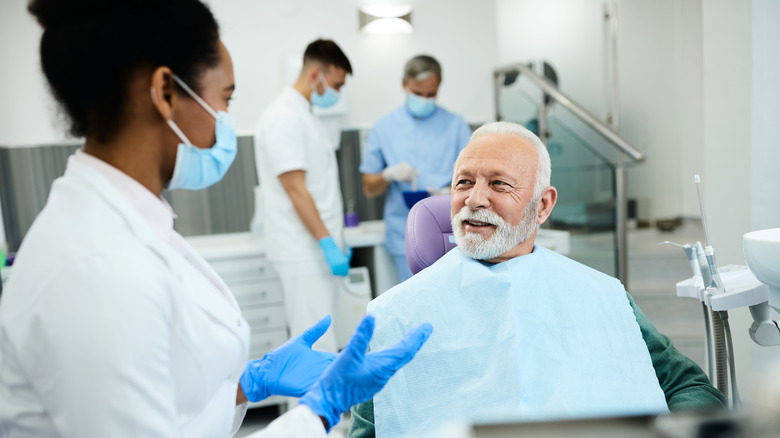 A dentist talking with her patient