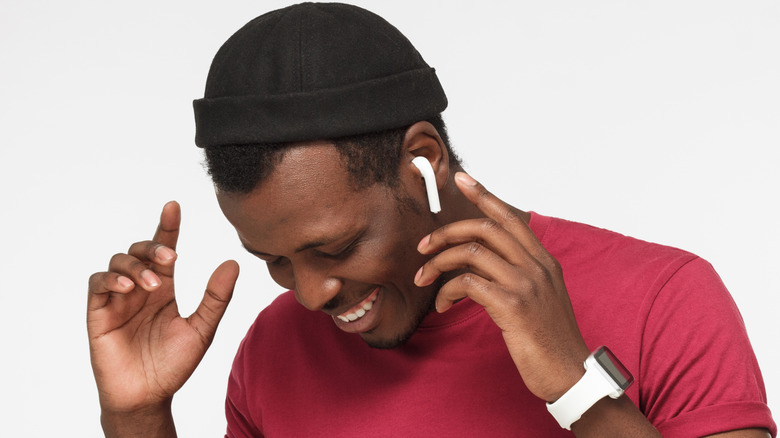 smiling man wearing earbuds