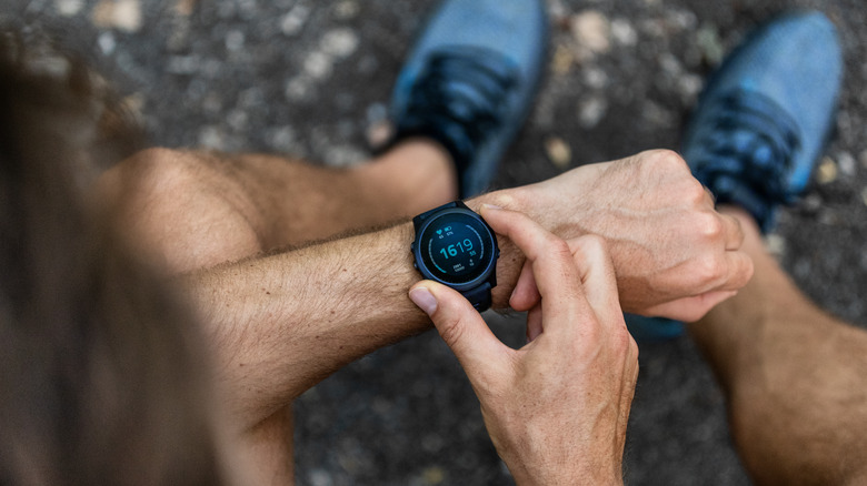 A man adjusts his smartwatch