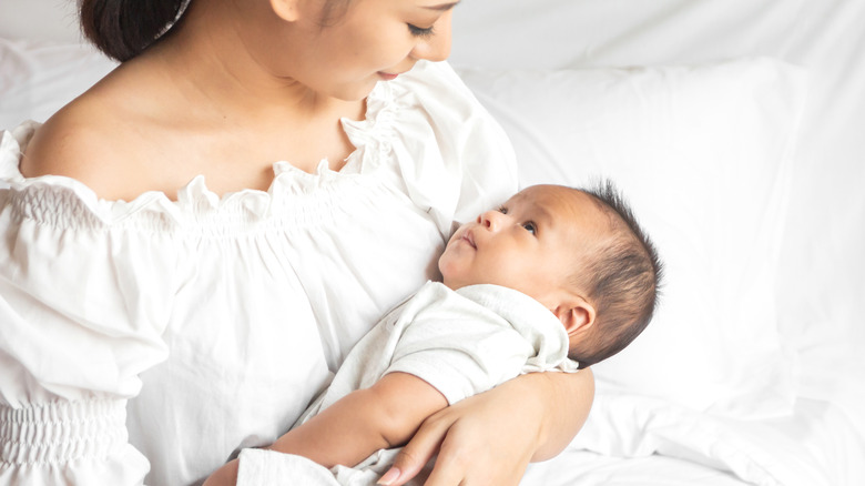 Closeup view of newborn baby breastfeeding in hospital