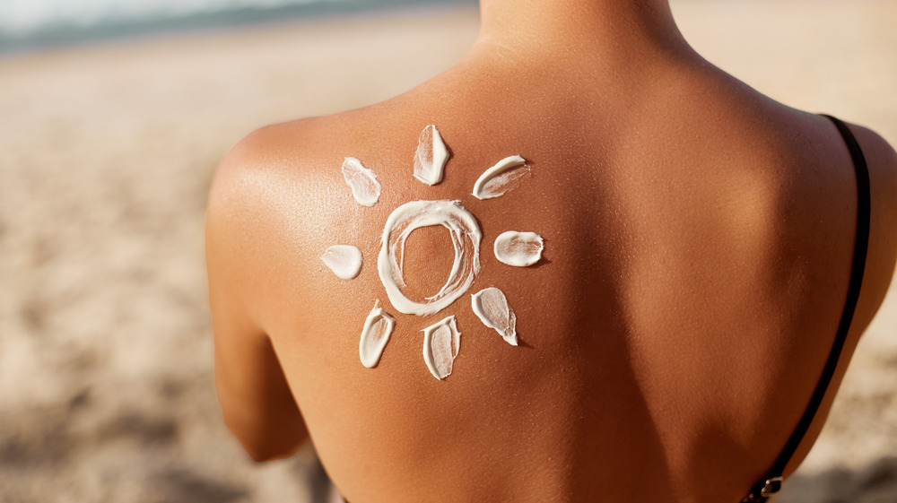 A sunscreen sun drawn on a woman's back 