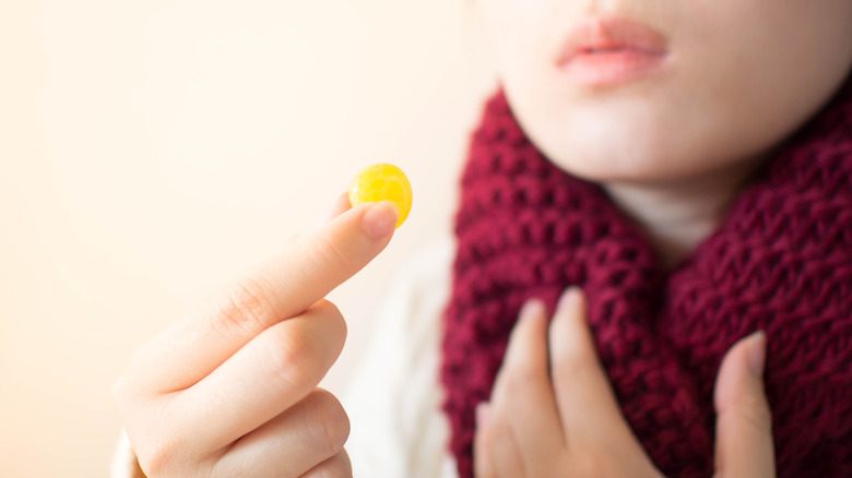 taking lozenge for sore throat