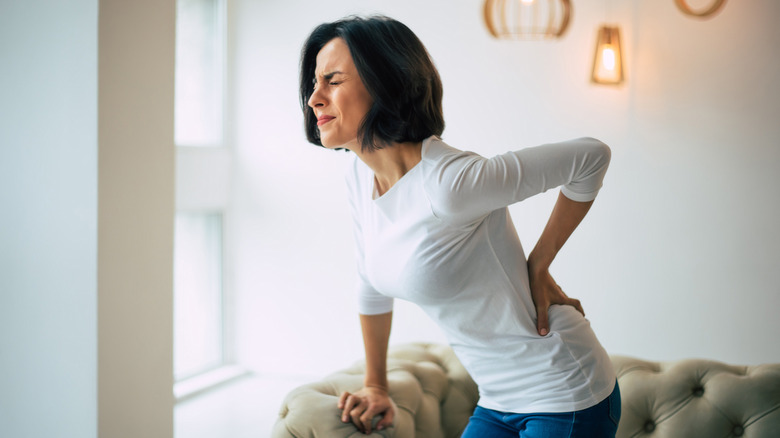 Woman holding her lower back