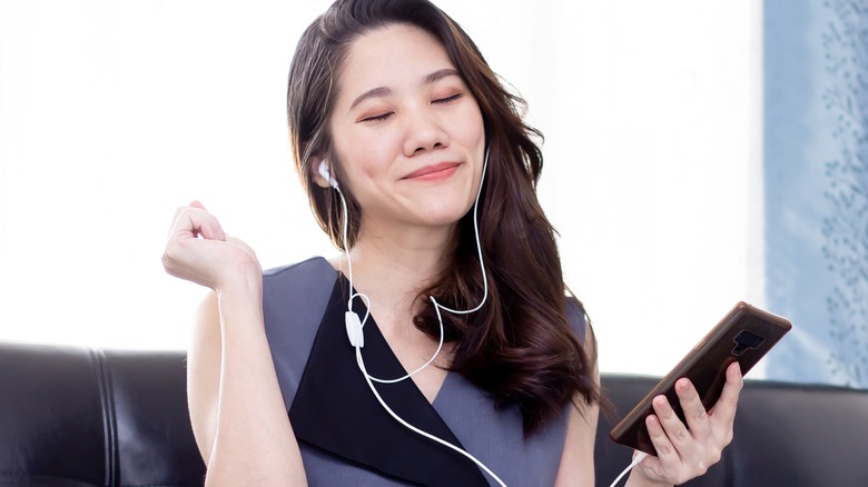 Woman with headphones humming