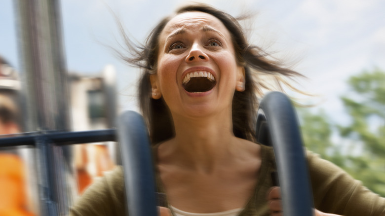 Screaming woman on roller coaster
