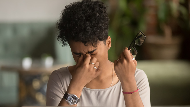 Woman closing her dry, tired eyes