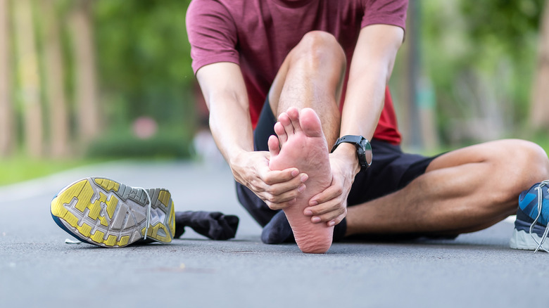 Man with athlete's foot rubbing his foot