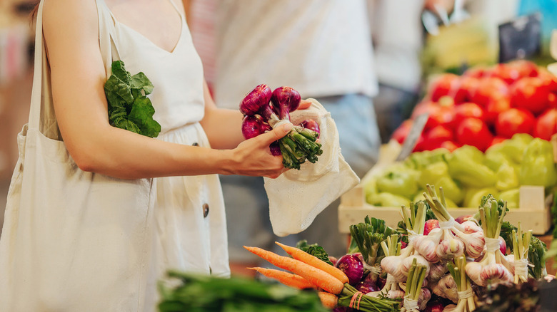 A woman shops for produce in the grocery store