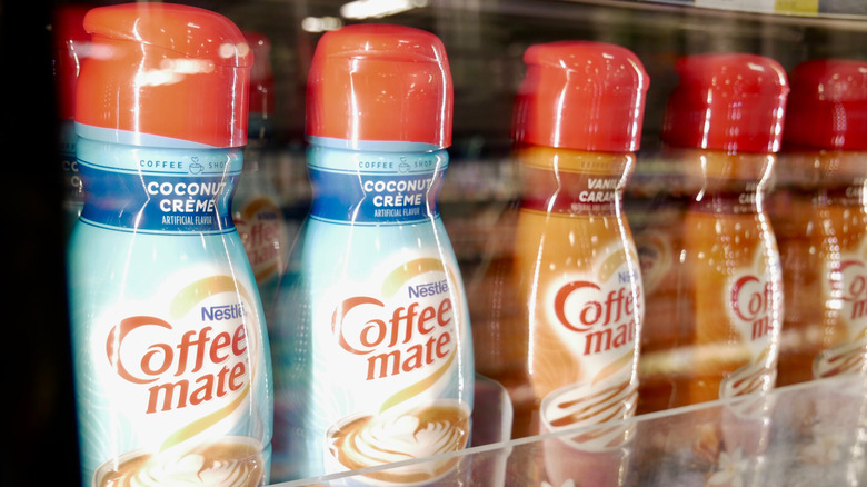 Several bottles of coffee creamer in a store