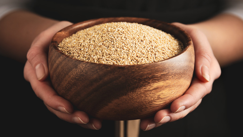 woman holding quinoa