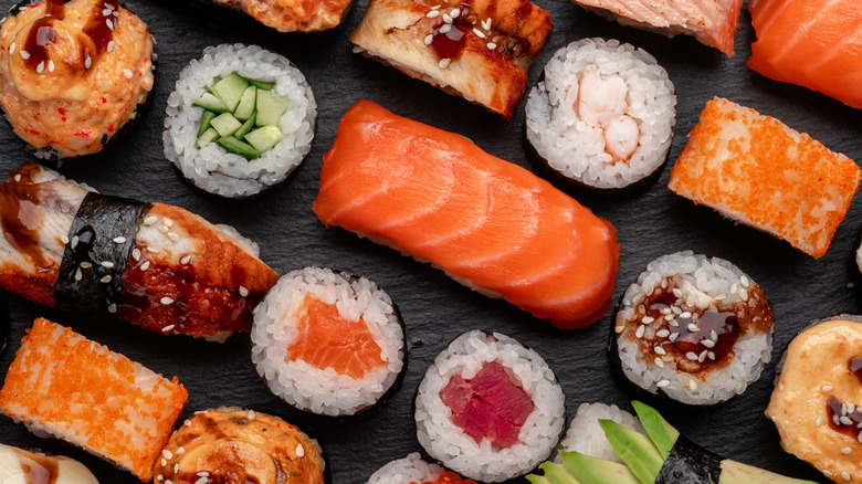 Different types of sushi on a black background