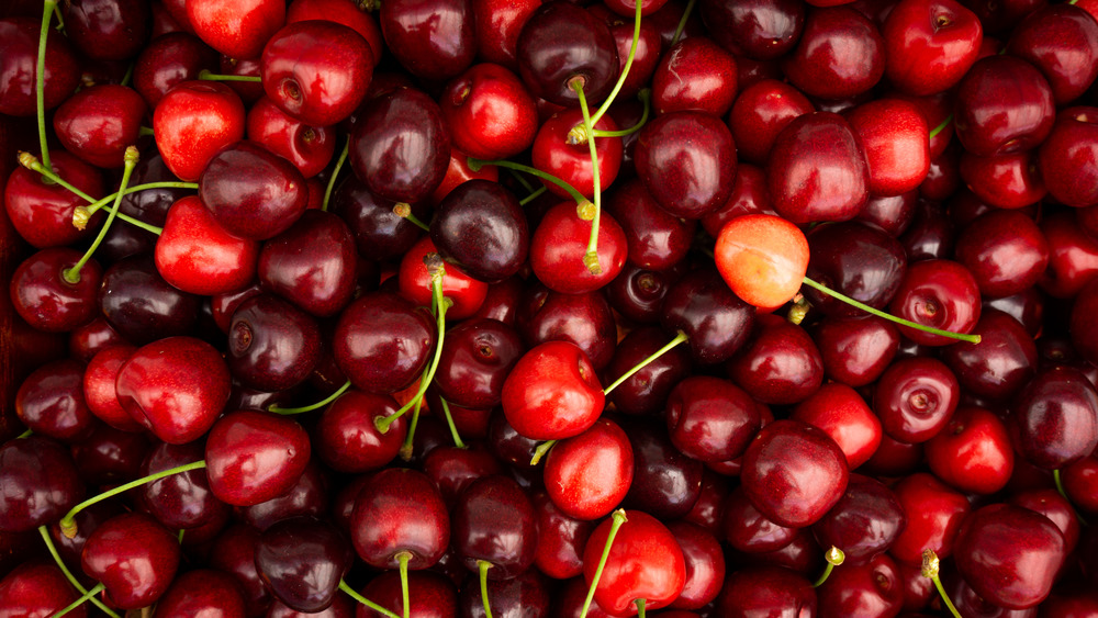A large dense pile of red cherries