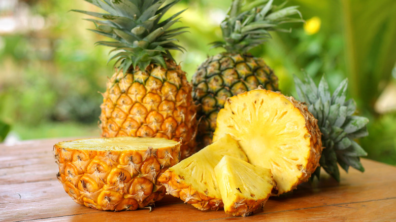 Three pineapples and one is cut in half