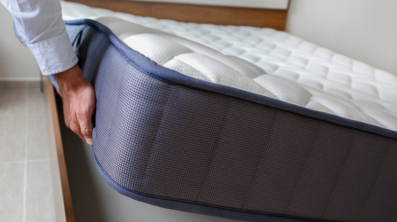 Pair of hands flipping mattress