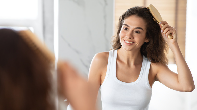 A woman brushes her hair