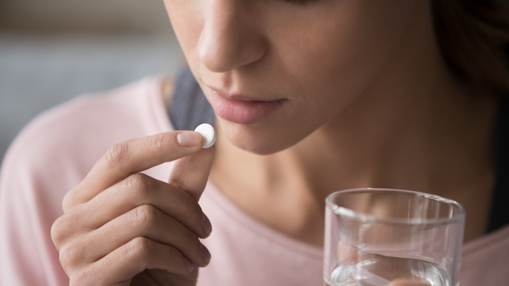 woman taking vitamin