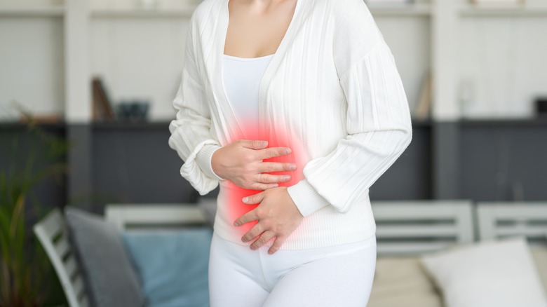 woman with holding stomach