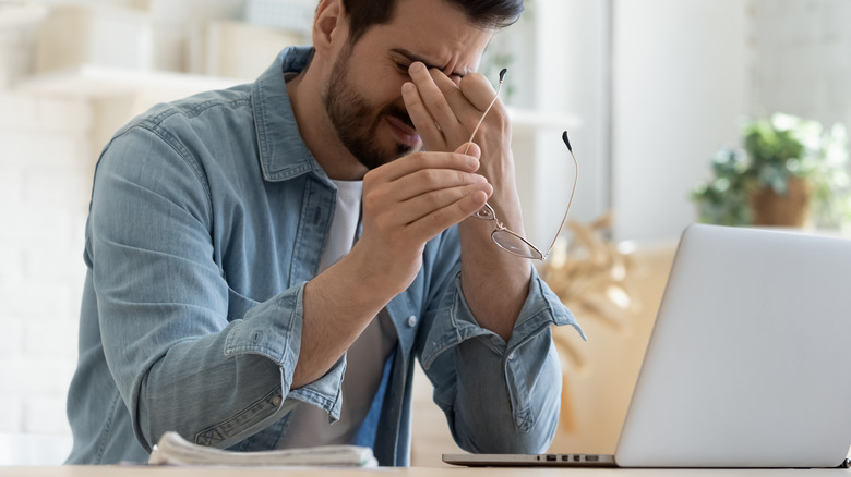 Man rubbing his eye