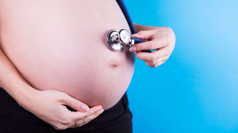 woman checking stomach 