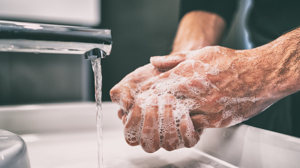 closeup of a man washing hands