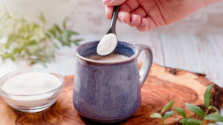 collagen powder being added to coffee