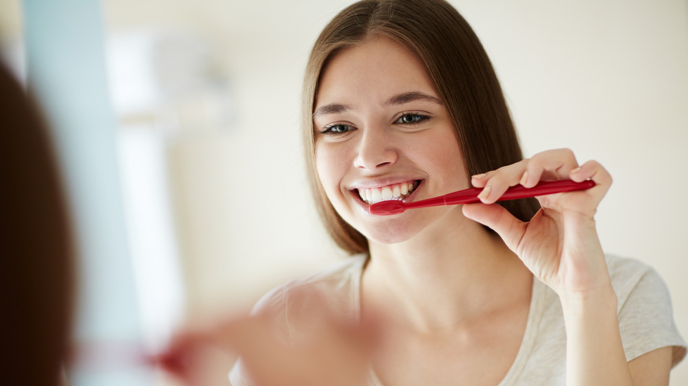 woman brushing teeth