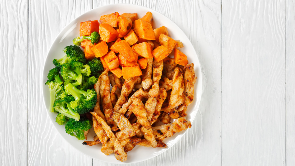 a plate of vitamin A rich broccoli, sweet potatoes, and chicken 
