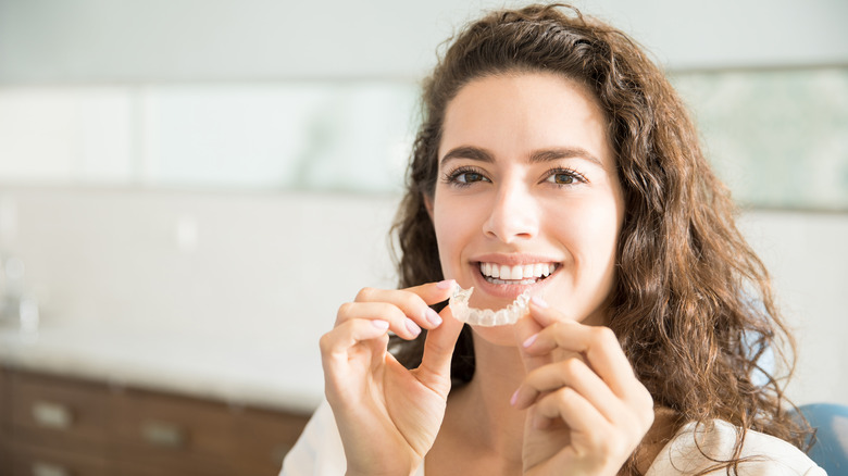 Woman holding a mouthguard