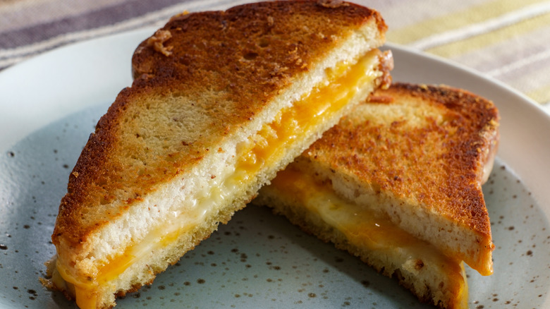 sliced grilled cheese sandwich made with American cheese